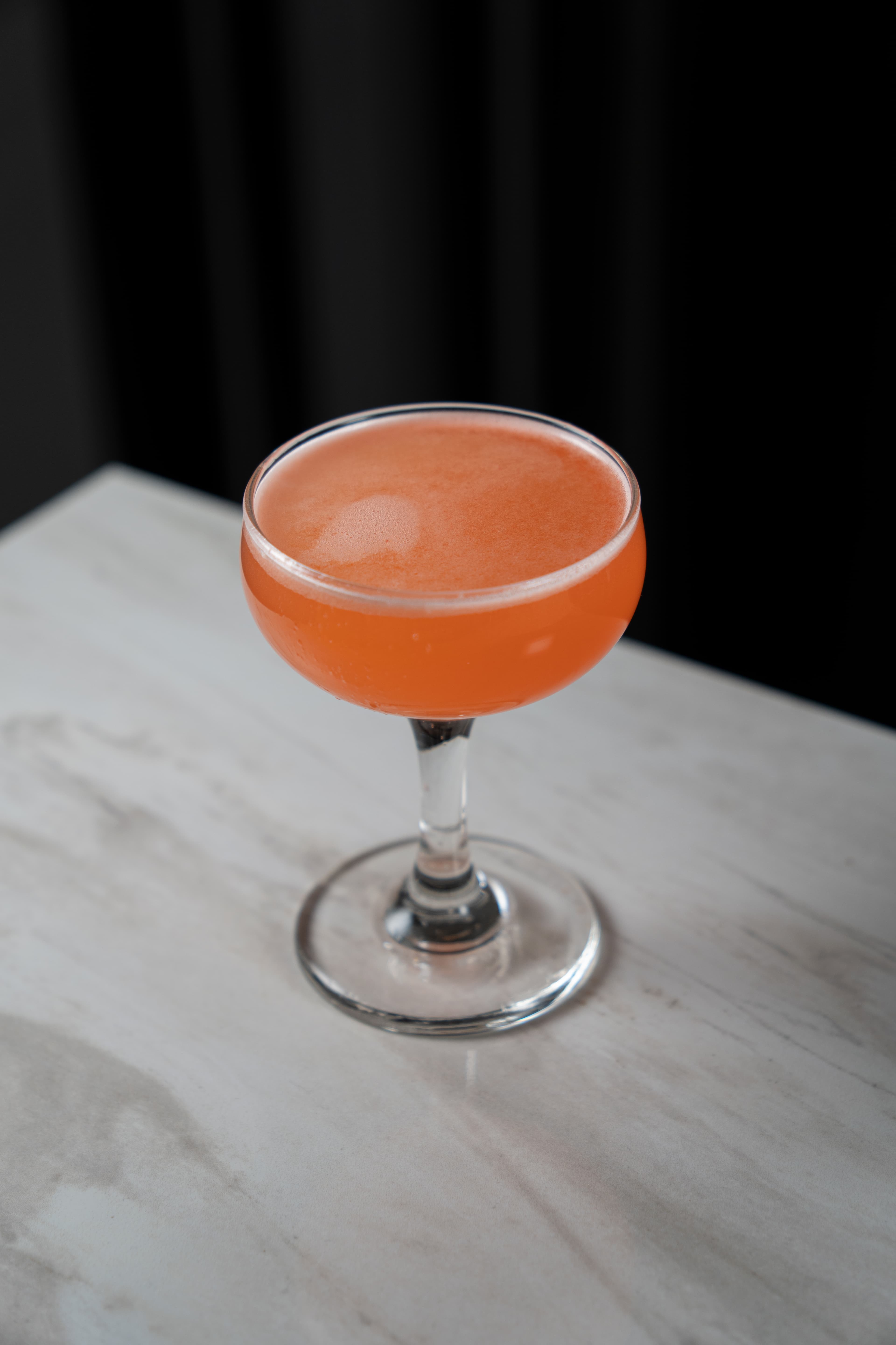 Two cocktails raised in a celebratory toast